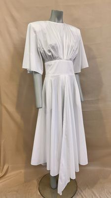 the mannequin is wearing a white dress on a mannequin stand
