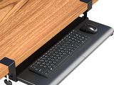 a computer desk with a keyboard and mouse on it
