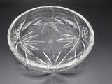 a clear glass bowl with a flower design on it