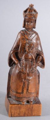 wooden statue of a woman sitting on a stool holding a basket