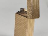 a gold lighter that is sitting on a table