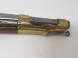 a close up of a gun on a table with a white background