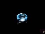 a close up of a blue topaz stone on a black surface