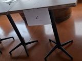 a table that has a sign on it in front of a window