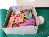 a cardboard box filled with assorted items on a green table