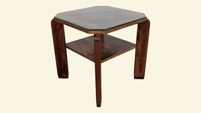 a small table with a glass top on a white background