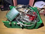a green basket filled with assorted items on a wooden table