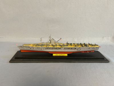 a model of a large ship on a wooden stand