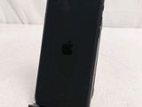 an iphone is sitting on top of a stand on a white surface