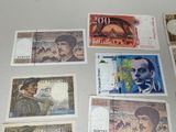 several different bank notes are laid out on a table