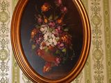 a picture of a painting on the wall above a clock