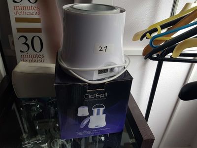 a white coffee pot sitting on top of a glass table