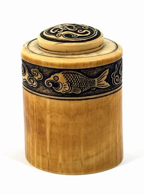 a wooden box with a fish design on it