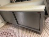 a kitchen counter with a sink and a stove in it