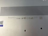 a laptop that has a green key on the back of it