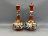 pair of orange and white vases sitting on top of a white table