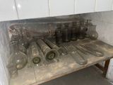 many bottles and knives on a shelf in a room