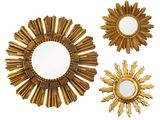 trois miroirs dorés à rayons de soleil sur fond blanc