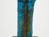 sculpture of a blue vase on a wooden stand with a white background