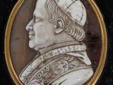 portrait of a man wearing a cap and a robe in a gold frame