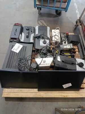 a lot of electronics on a pallet in a warehouse