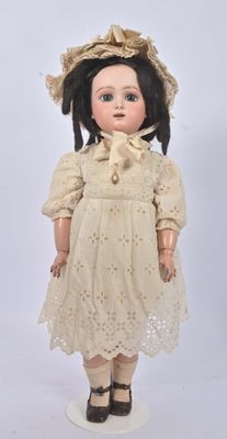 an image of a doll with a hat and dress on a white surface