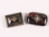 pair of tortoise shell cigarette cases on white background