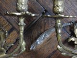 two candles that are sitting on a wooden table