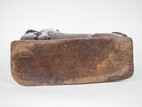 an old wooden box with a statue of a person laying on top of it