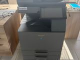 a photo of a multi - function printer sitting on top of a desk