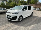 a small white van parked in a parking lot