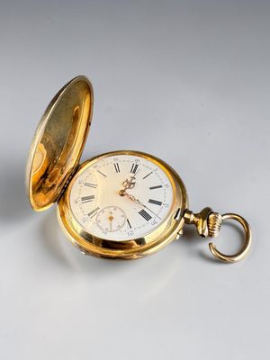 an old gold pocket watch with roman numerals and a chain