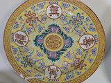 three plates with oriental designs on them on a table