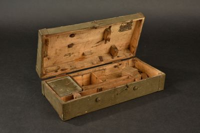 an old wooden box with a small drawer inside of it