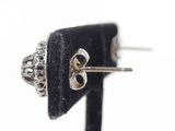 silver and black stone stud earrings on a black velvet stand