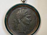 an old silver coin with a woman ' s face on it