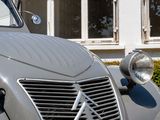 a silver car parked in front of a building