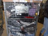 a metal cart with many items in it in a warehouse
