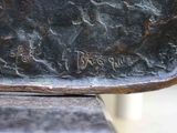 a close up of a bronze statue of a person