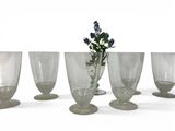 six wine glasses sitting next to each other on a table
