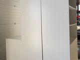 a white refrigerator sitting on a pallet in a warehouse
