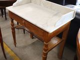 a table with a marble top and chairs in the background