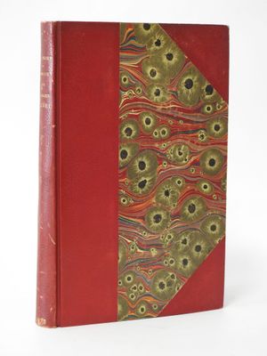 an old book with a red cover and a pattern on the cover