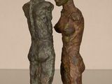 statue of a couple kissing each other on a marble base