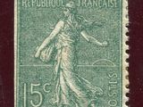 a stamp with a woman holding a flower on it
