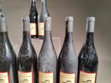 several bottles of wine are lined up on a table