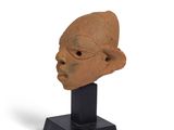 statue of a man ' s head on a black stand