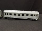 a white train car and a silver train car on a black background