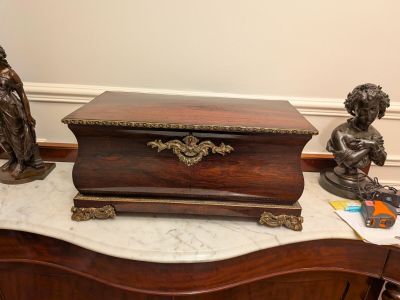 a small wooden box with a statue on top of it