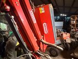 a red machine that is sitting in a garage